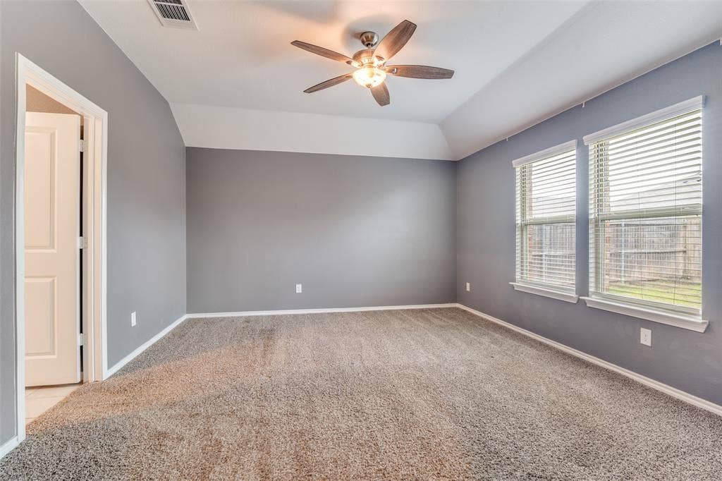 877 Darst Drive, Fate, TX 75189 Primary bedroom with ensuite bathroom and two walk in closets