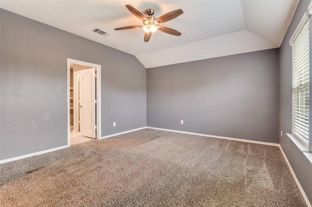 877 Darst Drive, Fate, TX 75189 Primary bedroom with ensuite bathroom and two walk in closets