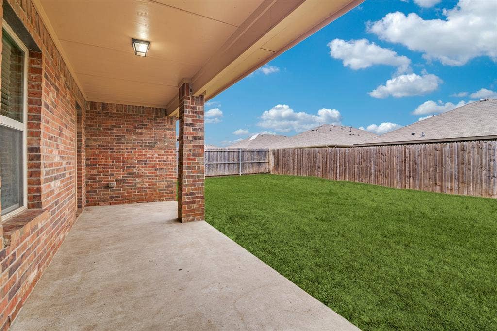 877 Darst Drive, Fate, TX 75189 Covered patio and fenced in backyard