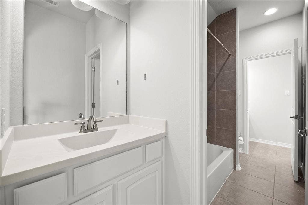 Vanity featuring a white countertop with an integrated sink and brushed nickel faucet