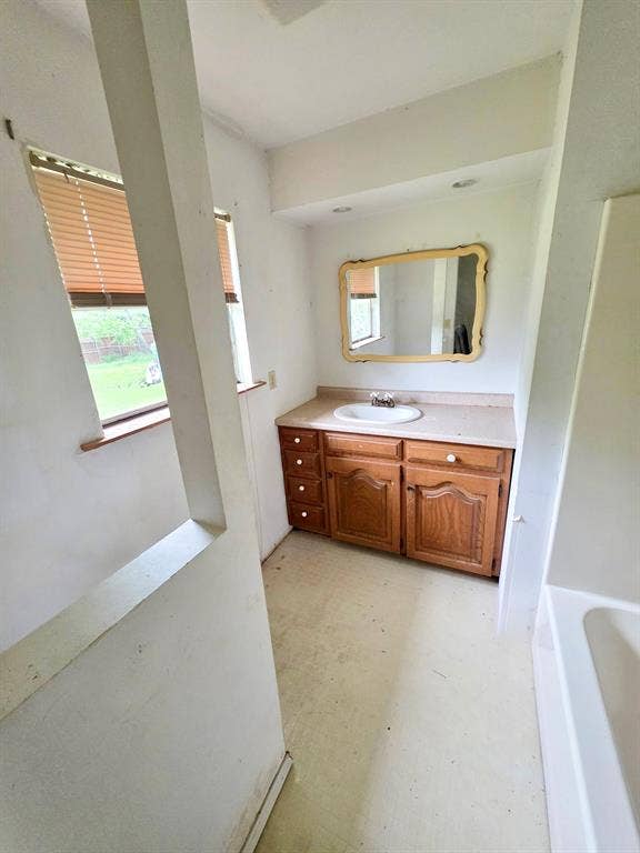 417 W Huffman Street, Krum, TX 76249 Vanity with wood-finish cabinetry, integrated sink, and countertop