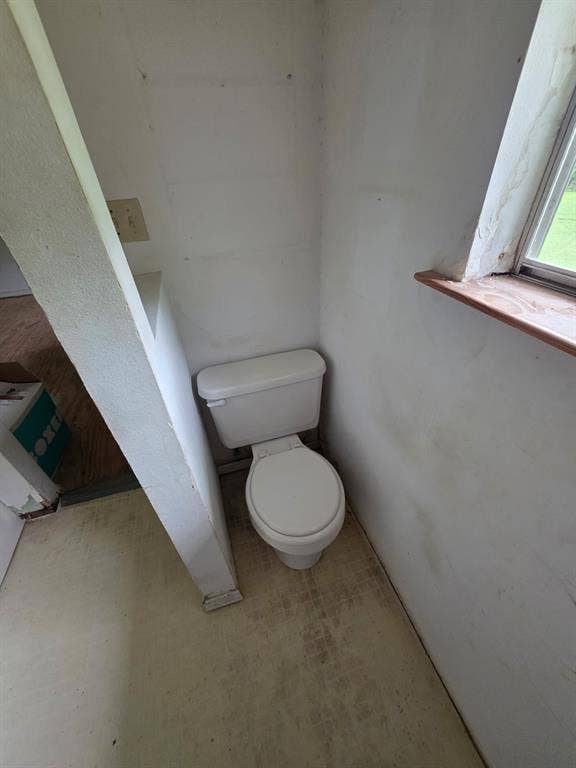 417 W Huffman Street, Krum, TX 76249 White ceramic toilet with a round bowl