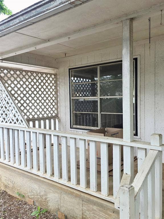 417 W Huffman Street, Krum, TX 76249 Covered porch with white painted railings and lattice detailing