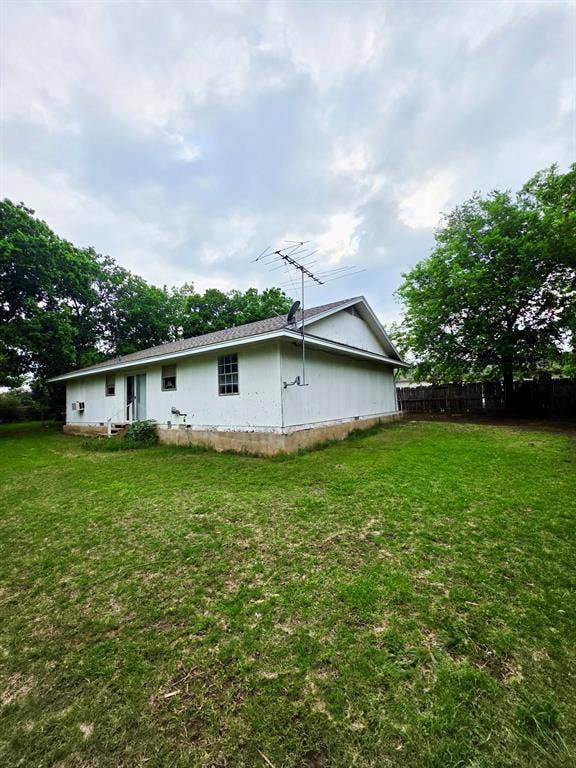 417 W Huffman Street, Krum, TX 76249 Single-story residence featuring white siding and a light-colored shingle roof