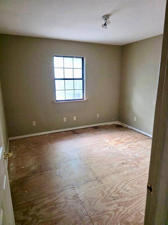 417 W Huffman Street, Krum, TX 76249 Room featuring a single window, baseboard trim, and a ceiling-mounted light fixture
