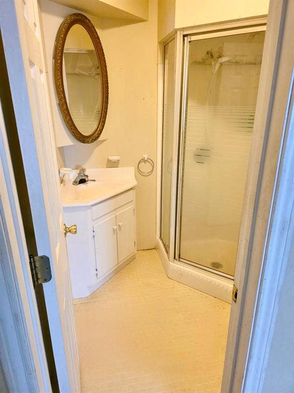 417 W Huffman Street, Krum, TX 76249 Bathroom featuring a corner shower enclosure and a vanity with a white countertop