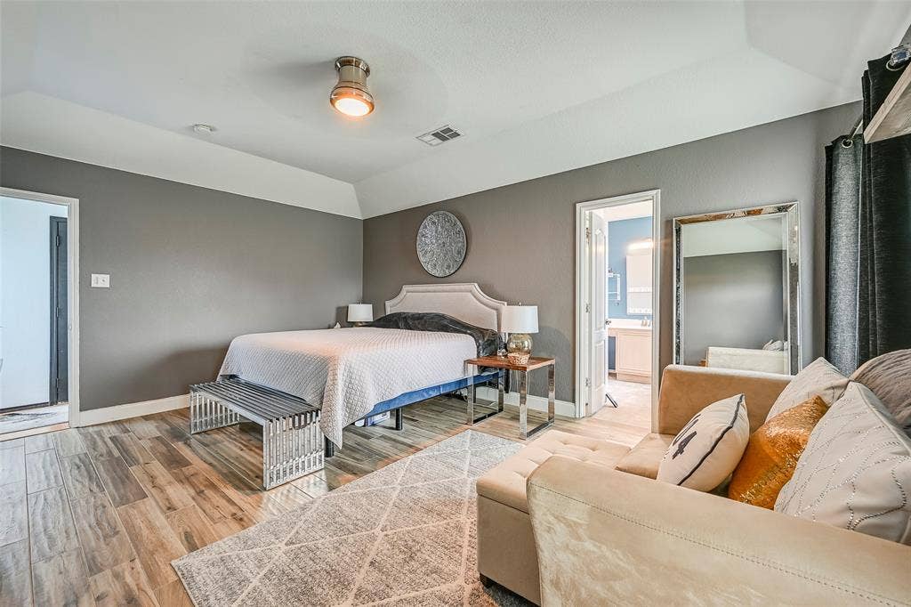 This room features wood-look tile flooring, gray walls, and white trim