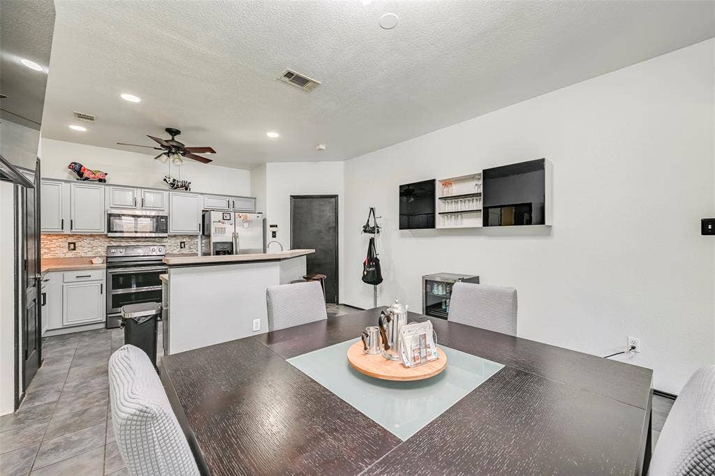 The property features an open-concept living area with a kitchen and a dining space