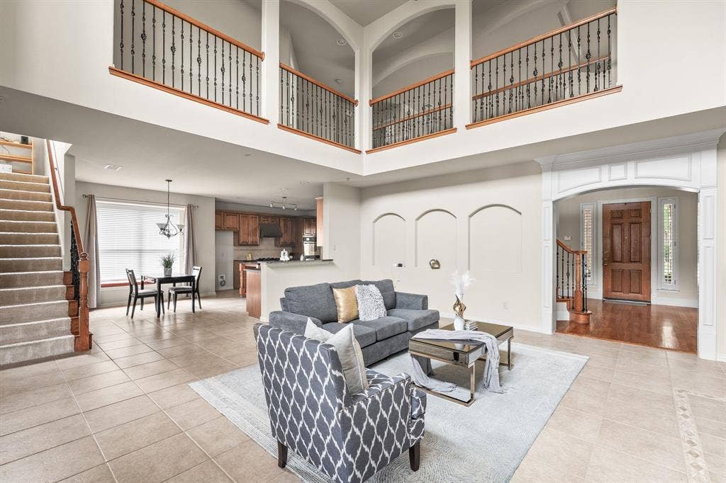 Large family room with soaring ceilings, tons of natural light. Rear staircase for convenience.