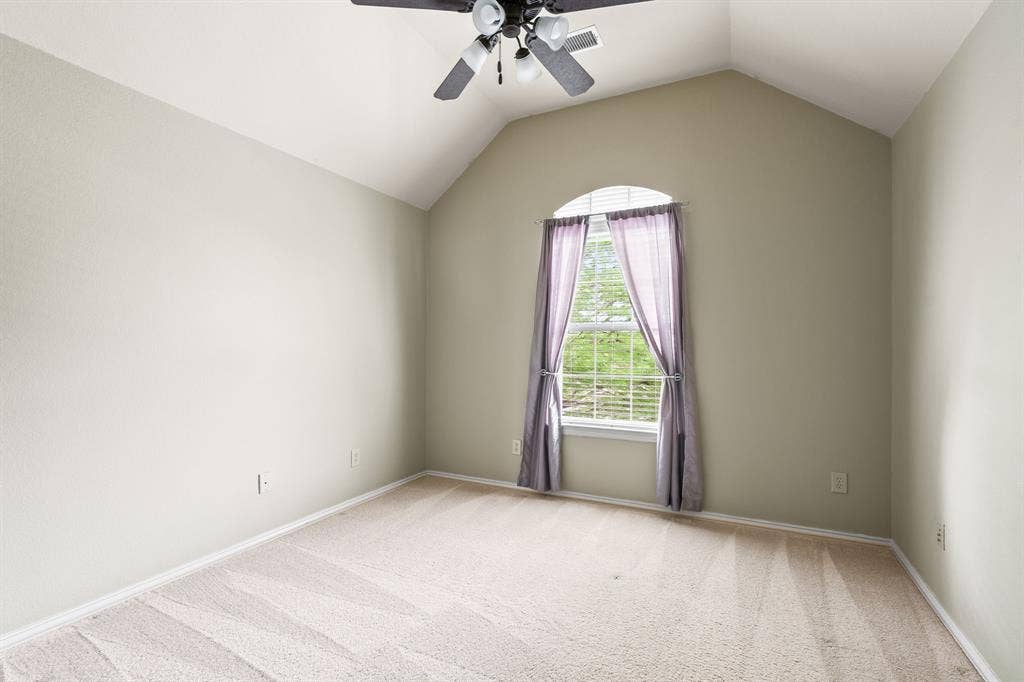 Upstairs bedroom with high ceilings and private bathroom.