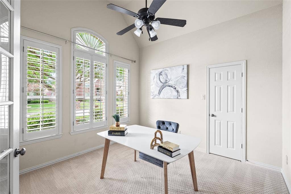 Large office with closet, soaring ceilings and plantation shutters.