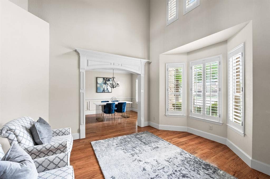 Beautiful formal iving room with tons of natural lights, plantation shutters and gorgeous moldings.