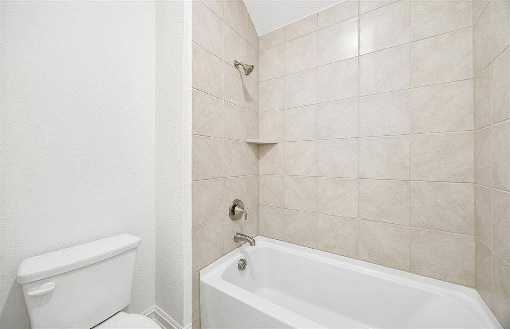 7337 Kurth Lane, McKinney, TX 75071 Secondary bath with tile surrounded shower