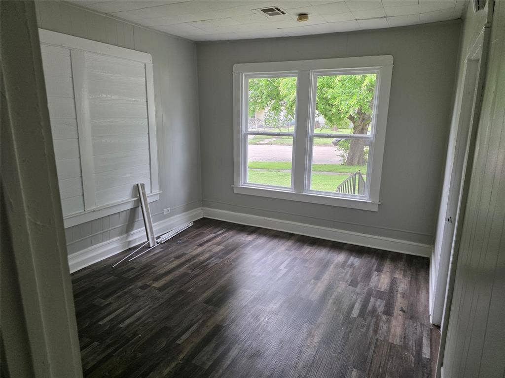 2523 Sanger Avenue, Waco, TX 76707 This room features dark-toned flooring, light gray walls, and white trim