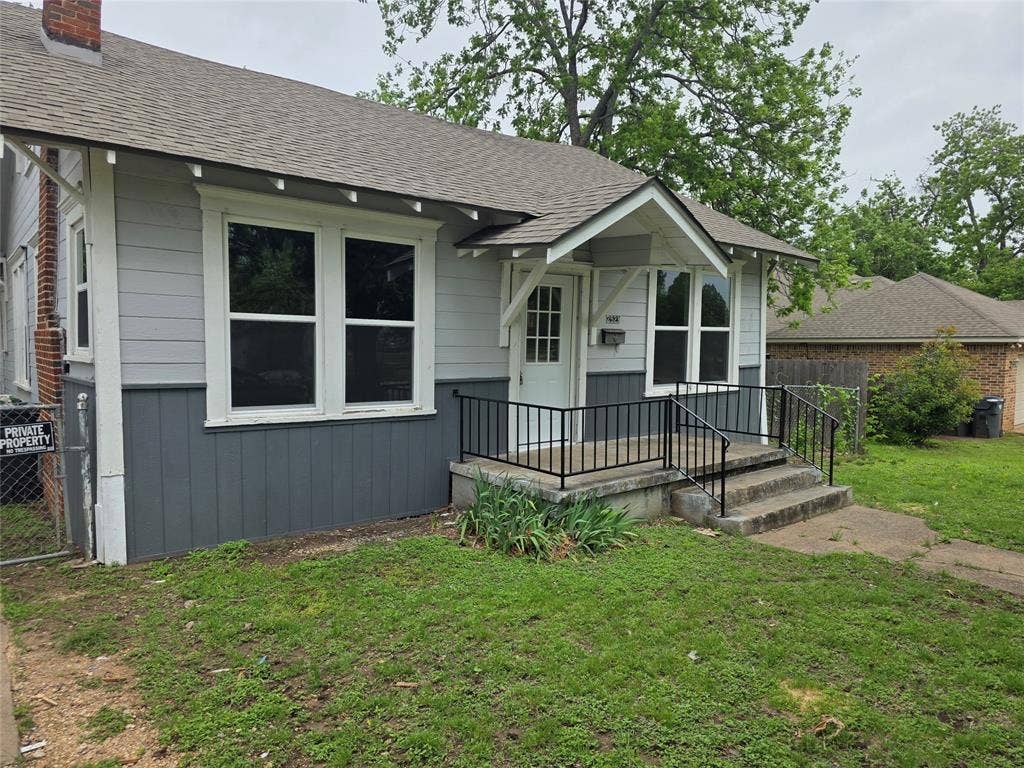 2523 Sanger Avenue, Waco, TX 76707 The property features a concrete porch with black metal railings, a light-colored front door
