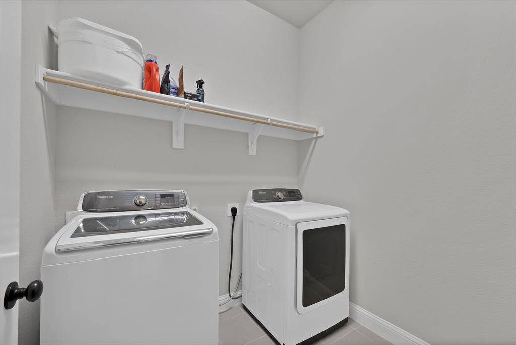 1905 Silver Falls Drive, Burleson, TX 76028 Dedicated laundry area featuring a white washing machine, dryer, and an overhead shelf
