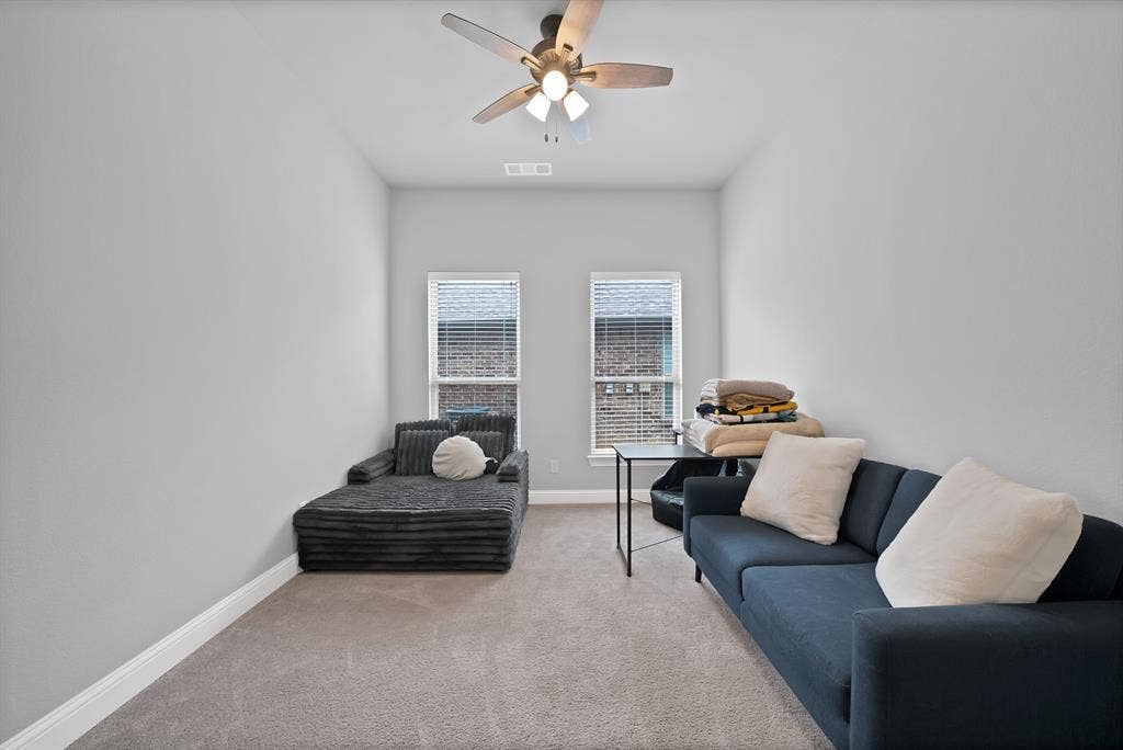 1905 Silver Falls Drive, Burleson, TX 76028 This versatile room features carpeted flooring, light grey walls, and two windows providing natural light