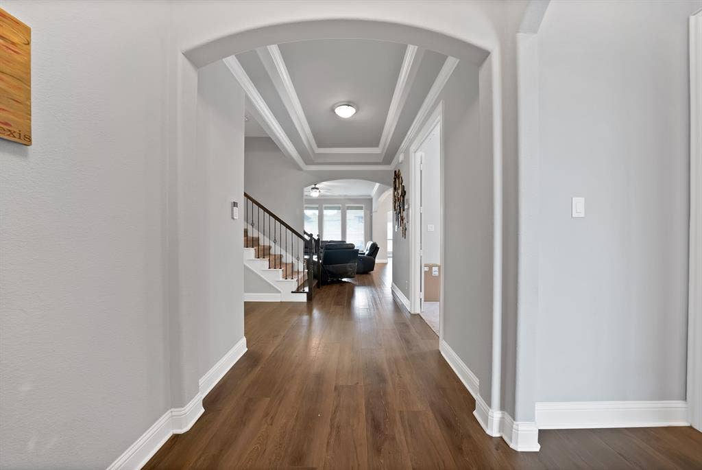 1905 Silver Falls Drive, Burleson, TX 76028 Inviting entryway featuring hardwood flooring, an arched doorway, and coffered ceilings