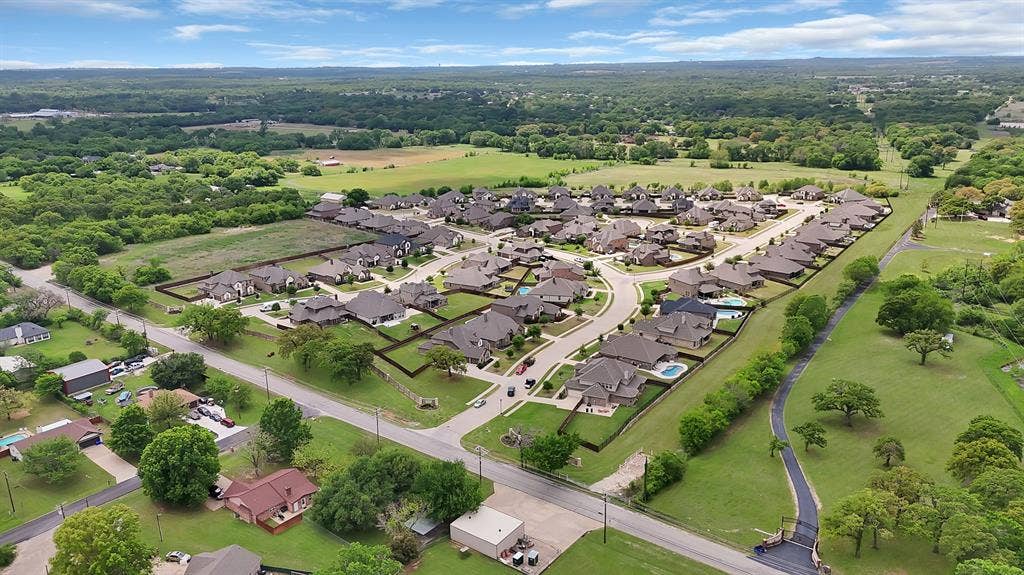 1905 Silver Falls Drive, Burleson, TX 76028 Aerial view showcasing a residential community with a variety of homes, each featuring a private yard
