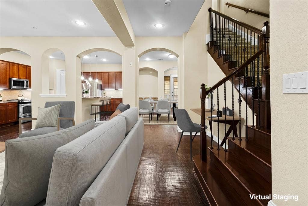 6748 San Roque, Irving, TX 75039 This property features rich hardwood flooring, a staircase with wrought iron balusters and wood handrails, and arched doorways