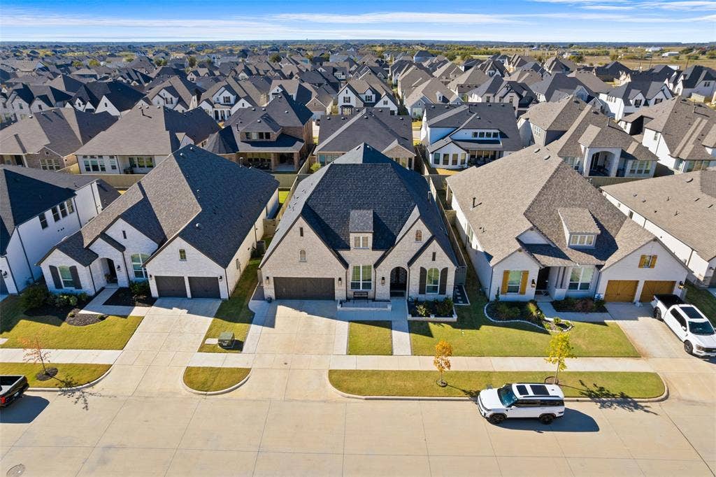 216 Shetland Lane, Northlake, TX 76247 This property features a well-maintained lawn and a paved driveway leading to a two-car garage