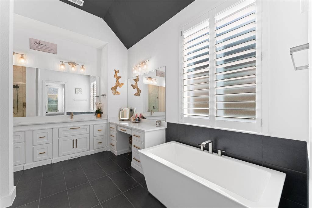 216 Shetland Lane, Northlake, TX 76247 Spacious bathroom featuring a freestanding soaking tub, a large vanity with dual sinks, and a makeup vanity