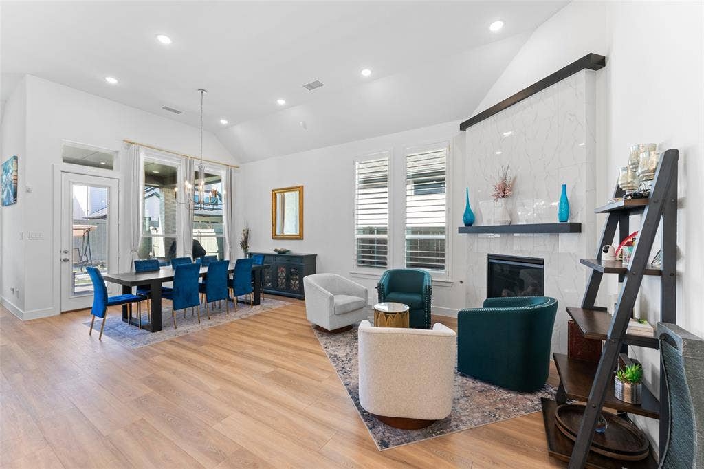 216 Shetland Lane, Northlake, TX 76247 This spacious living area features high vaulted ceilings, light wood flooring, and recessed lighting throughout