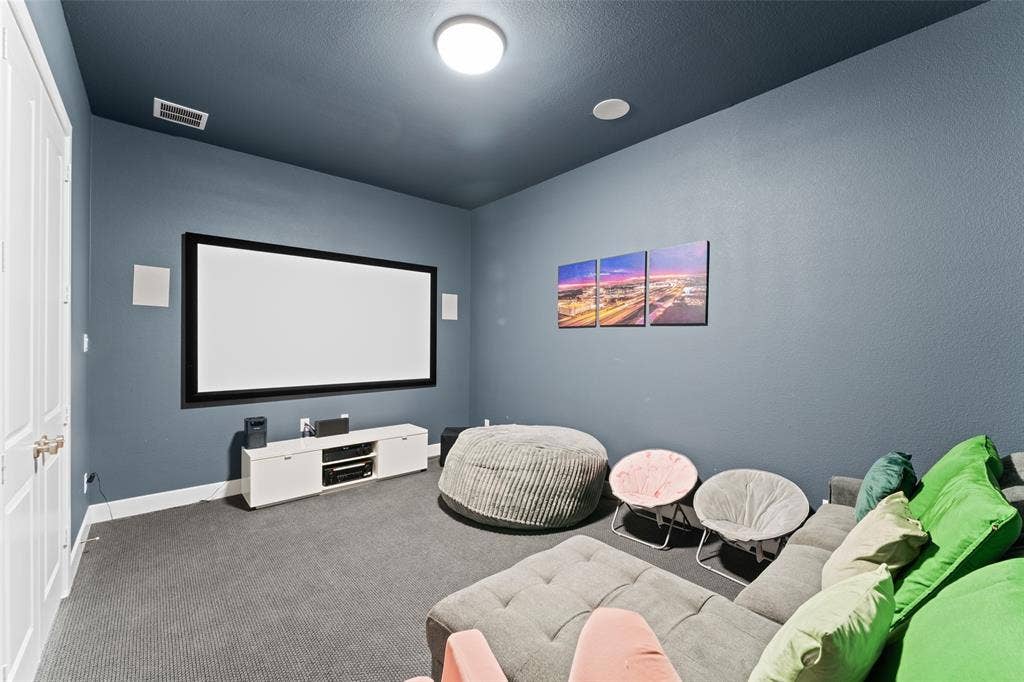 216 Shetland Lane, Northlake, TX 76247 This room features a large projection screen, recessed ceiling lights, and a wall-mounted ceiling light fixture