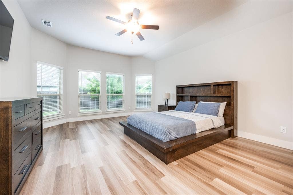 2801 Bedford Road, Northlake, TX 76226 The spacious primary suite has plenty of room for a large bed (queen shown) and furniture plus bay windows perfect for a sitting area.