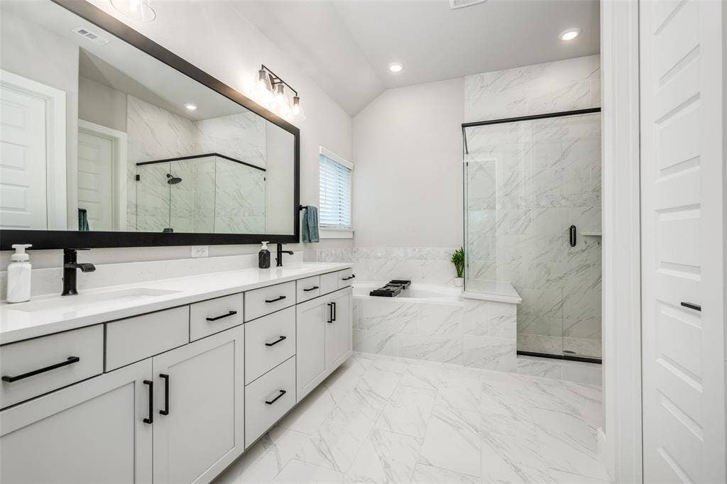2801 Bedford Road, Northlake, TX 76226 Spacious, sleek, and modern en suite bath with dual sinks, a large garden tub and large shower with bench seat.