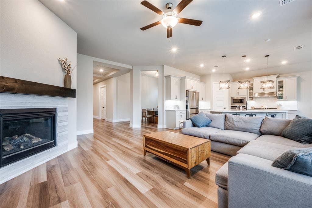 2801 Bedford Road, Northlake, TX 76226 The main living area is spacious, bright, and wide open. Enjoy the gas fireplace and show off your large TV or artwork above the stained wooden mantle.