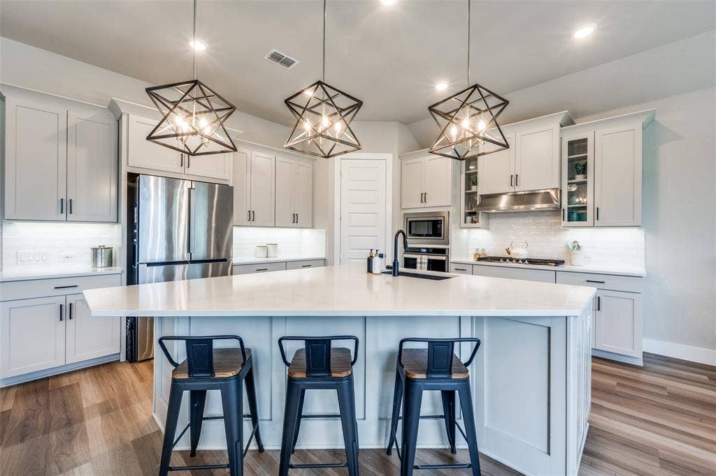 2801 Bedford Road, Northlake, TX 76226 The corner kitchen offers plenty cabinet space and a large island, perfect for serving and entertaining.