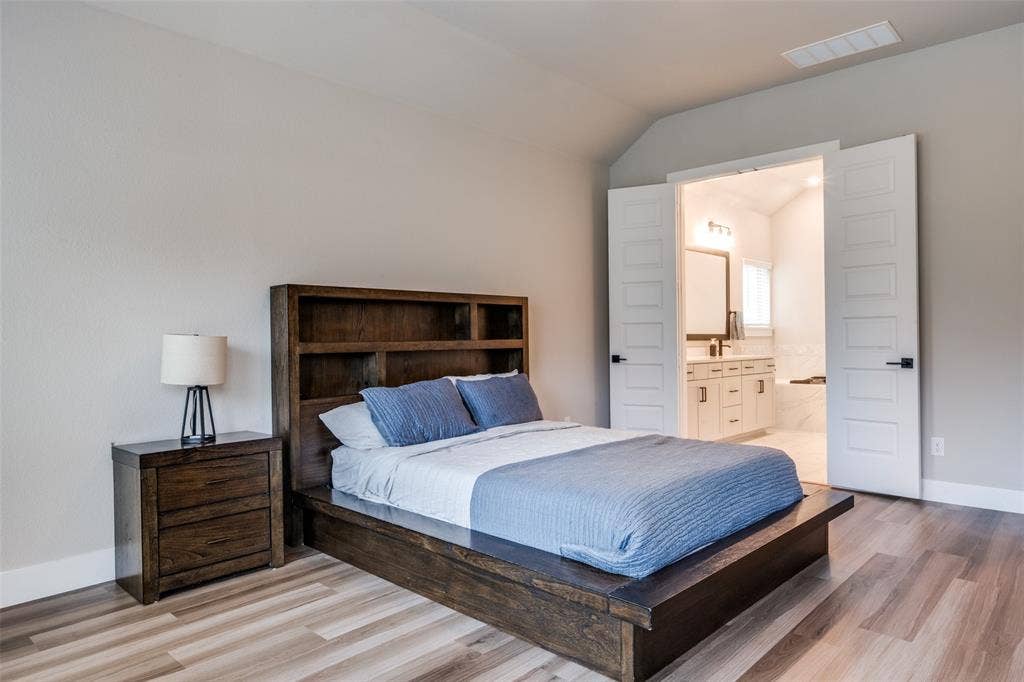2801 Bedford Road, Northlake, TX 76226 Spacious room has gorgeous LVP flooring and decorative doors providing privacy to the en suite bath.