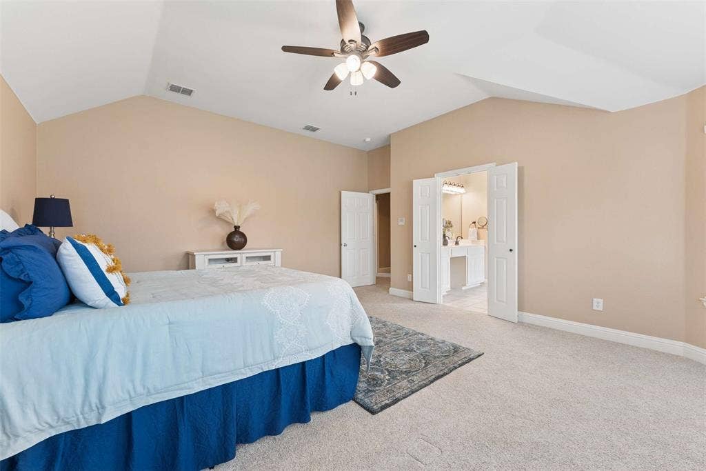 1221 Amistad Drive, Prosper, TX 75078 Spacious room featuring vaulted ceilings, a ceiling fan, and light-colored carpeting