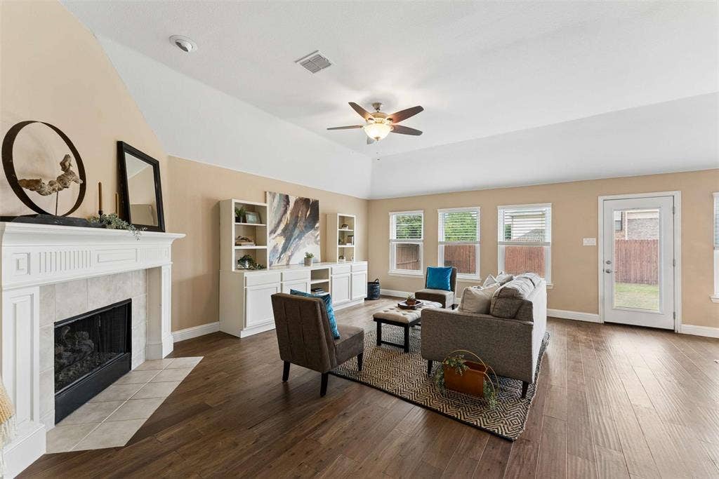 1221 Amistad Drive, Prosper, TX 75078 Living area featuring hardwood style flooring, a ceiling fan, and multiple windows providing natural light