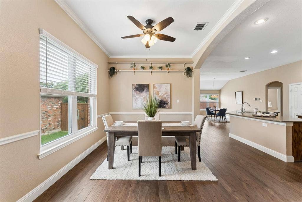 1221 Amistad Drive, Prosper, TX 75078 Dining area featuring hardwood floors, a ceiling fan with integrated lighting, and crown molding