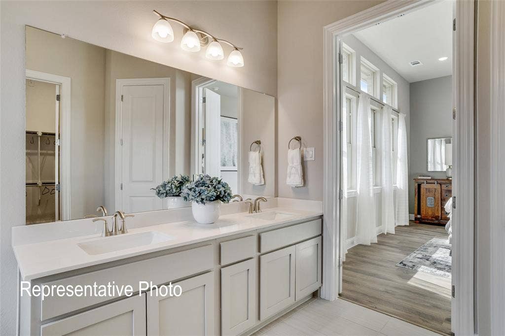 1415 Odette Drive, Arlington, TX 76013 Bathroom featuring a dual sink vanity with light-colored cabinetry and a large mirror