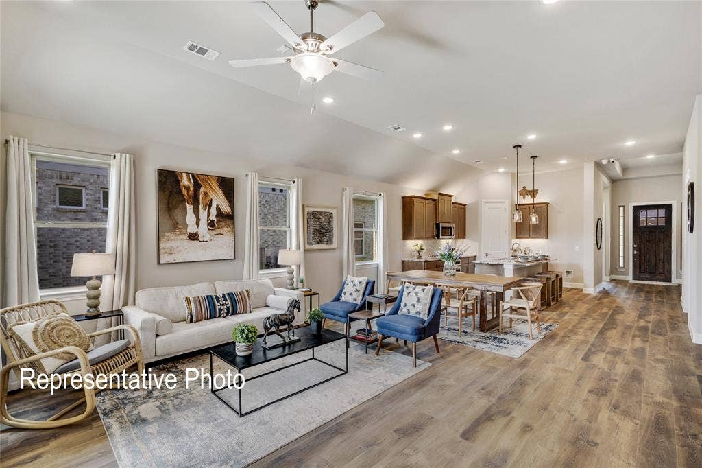 1415 Odette Drive, Arlington, TX 76013 The property features an open-concept living area with vaulted ceilings, recessed lighting, and a ceiling fan