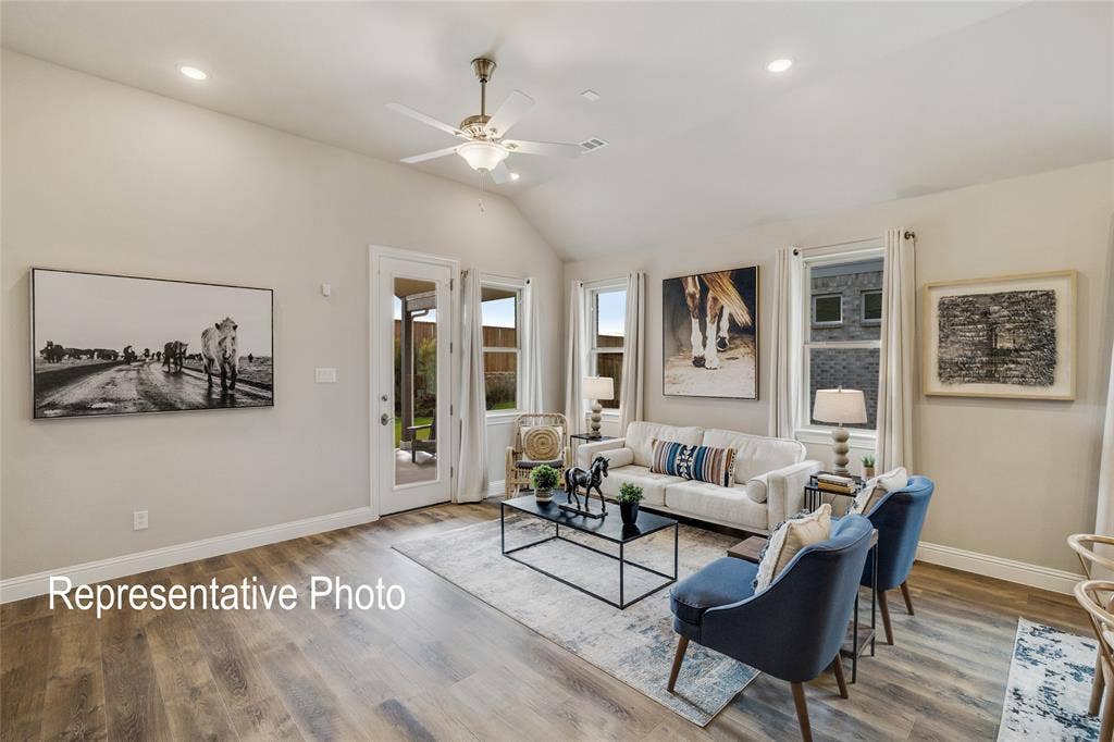1415 Odette Drive, Arlington, TX 76013 The living room features vaulted ceilings, recessed lighting, and wood-look flooring