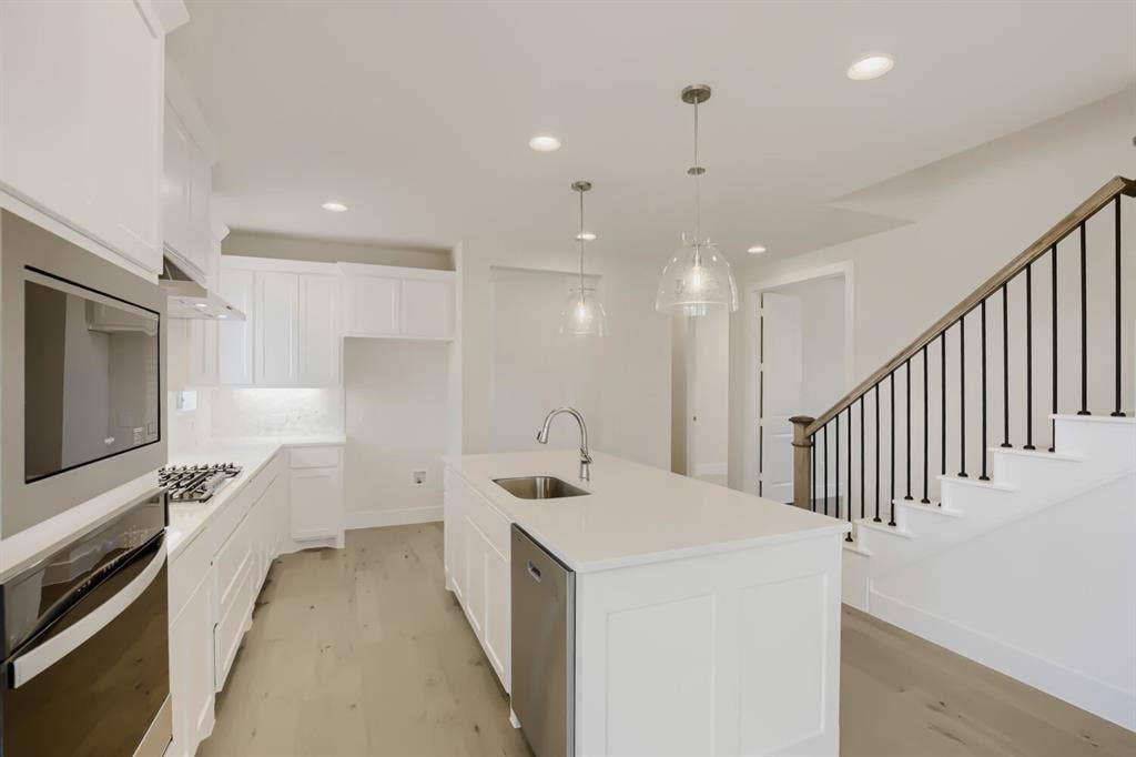 828 Stone Grove Road, Lavon, TX 75166 Modern kitchen featuring white cabinetry, light-toned countertops, and stainless steel appliances