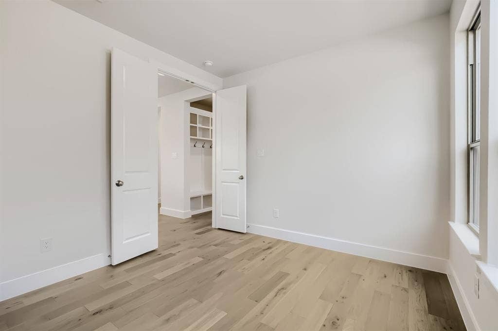 828 Stone Grove Road, Lavon, TX 75166 Bright room featuring wood-finish flooring, white walls, and a window with white trim