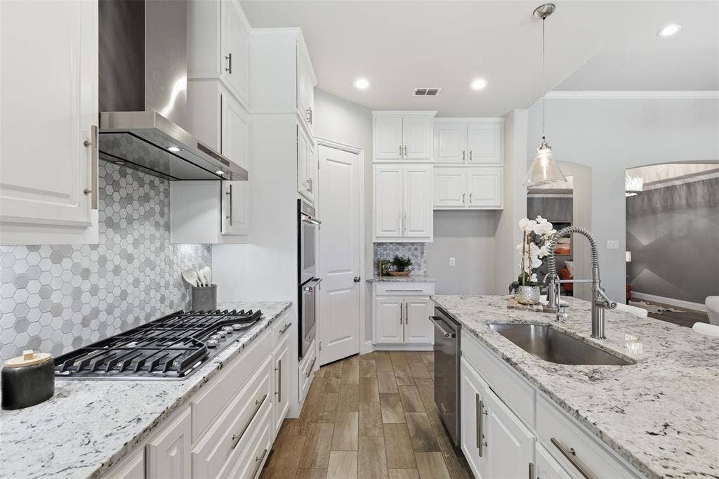 11414 Alejandra Lane, Frisco, TX 75035 Modern kitchen featuring white cabinetry and light-toned countertops