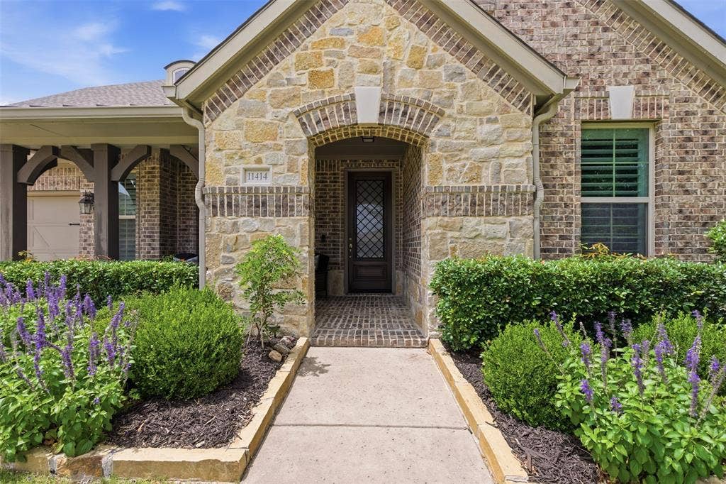 11414 Alejandra Lane, Frisco, TX 75035 Stone and brick exterior with arched entryway