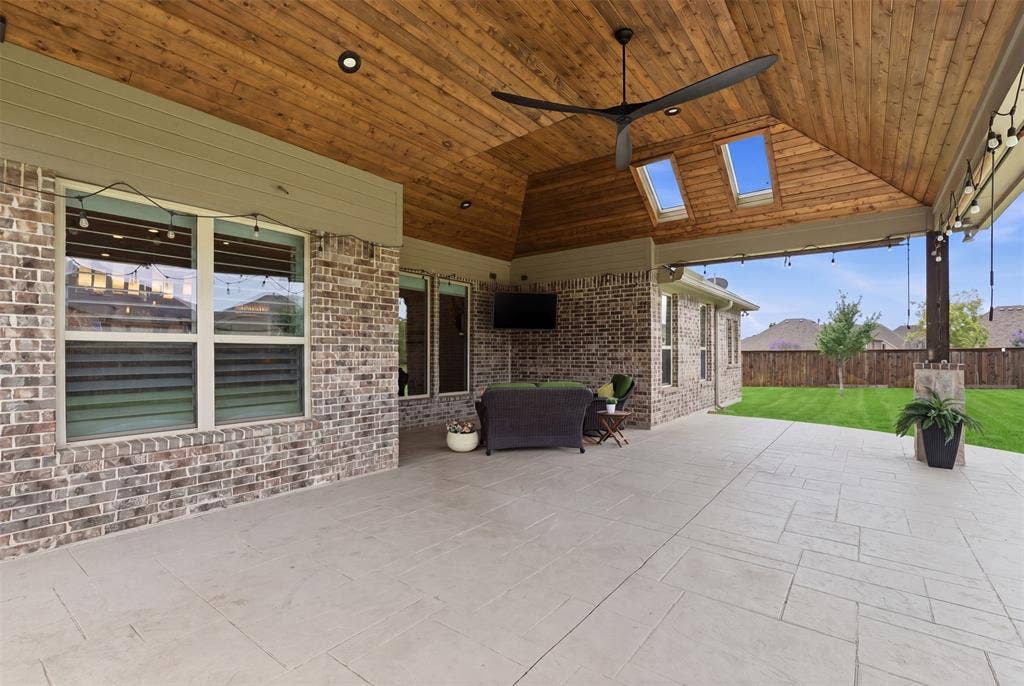 11414 Alejandra Lane, Frisco, TX 75035 This stunning patio features a vaulted tongue-and-groove cedar ceiling with skylights, oversized modern fan, recessed lighting