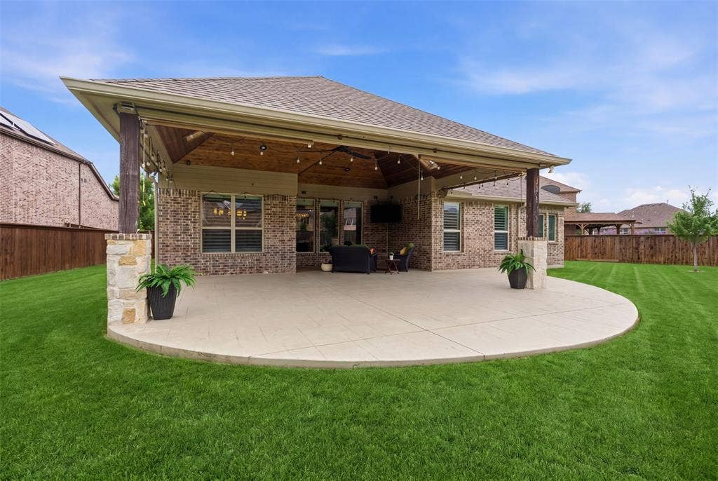 11414 Alejandra Lane, Frisco, TX 75035 The spacious tiled patio overlooks a large, beautifully maintained backyard—perfect for relaxing evenings or hosting guests in style.