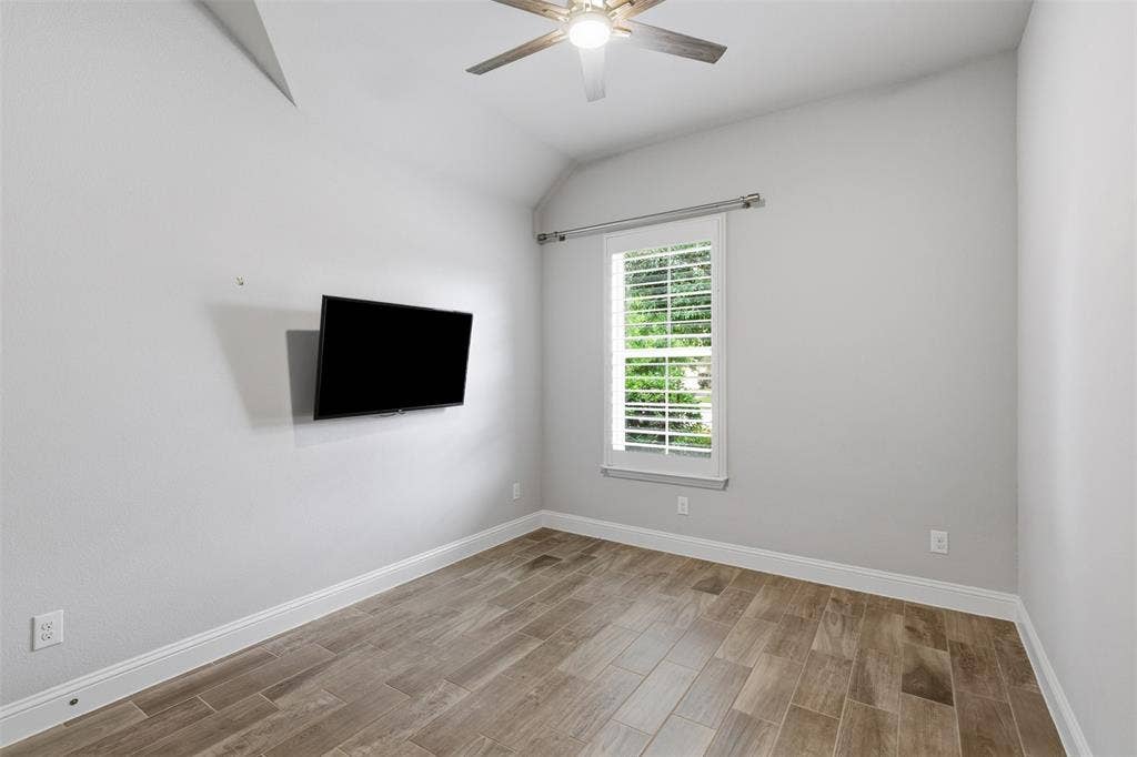 11414 Alejandra Lane, Frisco, TX 75035 1st floor secondary bedroom with vaulted ceiling and plantation shutters