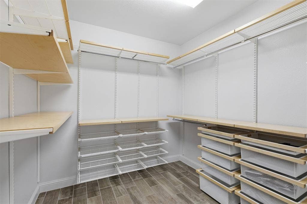 11414 Alejandra Lane, Frisco, TX 75035 Walk-in closet featuring wood-finish shelving and wire baskets, wire rack storage, wood-finish flooring, and recessed lighting