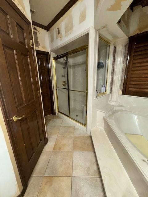 Full bath featuring a bath, ornate columns, ornamental molding, tile patterned flooring, and a stall shower