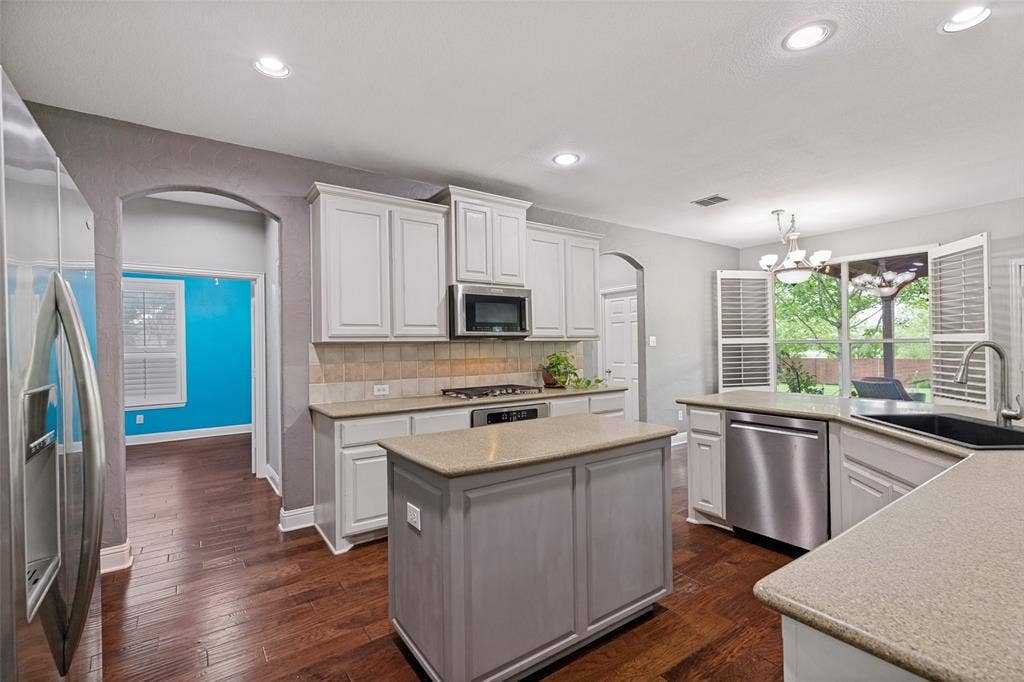 Island kitchen boasts loads of counter and cabinet space.