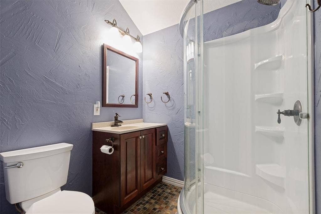 Full upstairs bath serves two bedrooms while a Jack-and-Jill bath joins the other two.